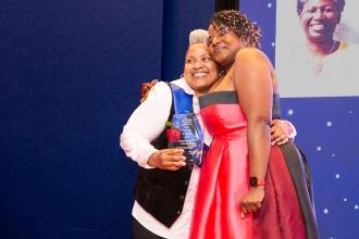 UFT Vice President for Academic HS Janella Hinds hugs award winner Wanda Linares at the 2024 UFT Academic High School Awards. 