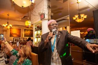 UFT District 9 Representative Aqeel Williams belts out a song at the UFT Italian American Heritage Committee dinner. 