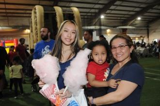 A mother, her daughter and grandson take a group photo at UFT Family Day on March 29, 2025.