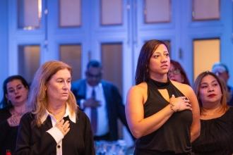 Members in attendance stand for the pledge of allegiance at the 2024 UFT Jewish Heritage Committee Tikkun Olam Awards Dinner on Dec. 5, 2024. 
