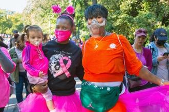 Regina Dukes (left), the paraprofessional representative at P79 in Manhattan, carries her daughter while she walks with her sister, Georgy Whitfield.