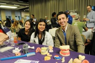 Tottenville High School students and their teacher take a photo at their exhibit hall table during the 2025 UFT Spring Education Conference. 